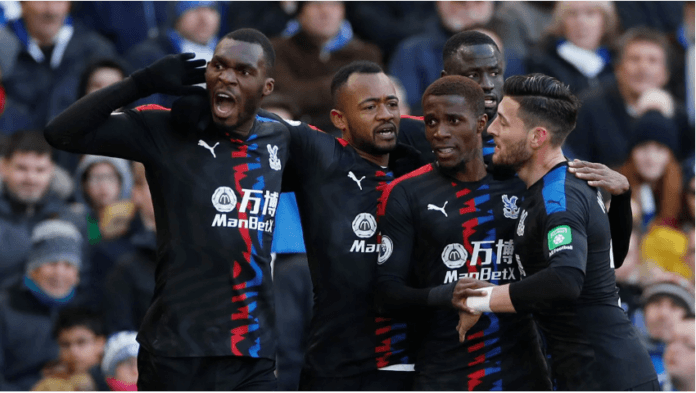 Jordan Ayew celebrates with Palace teammates