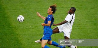 HANOVER, GERMANY - JUNE 12: Samuel Kuffour of Ghana thwarts the progress of Alberto Gilardino of Italy during the FIFA World Cup Germany 2006 Group E match between Italy and Ghana played at the Stadium Hanover on June 12, 2006 in Hanover, Germany. (Photo by Shaun Botterill/Getty Images)