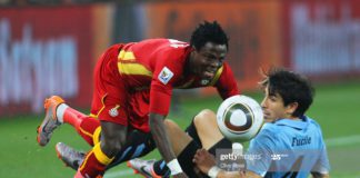 JOHANNESBURG, SOUTH AFRICA - JULY 02: Jorge Fucile of Uruguay tackles Samuel Inkoom of Ghana during the 2010 FIFA World Cup South Africa Quarter Final match between Uruguay and Ghana at the Soccer City stadium on July 2, 2010 in Johannesburg, South Africa. (Photo by Clive Rose/Getty Images)