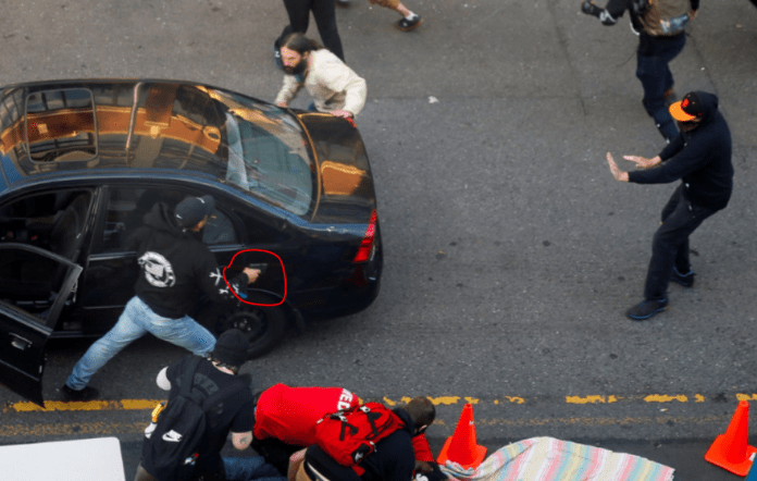 Man drives car toward Seattle protesters then shoots one, police say