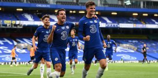 Mason Mount of Chelsea celebrates with teammate Cesar Azpilicueta after scoring his team's first goal during the Premier League match between Chelsea FC and Wolverhampton Wanderers at Stamford Bridge on July 26, 2020 in London, England. Football Stadiums Image credit: Getty Images