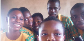 Gideon Nhyiraba and some of his classmates take a picture after writing BECE