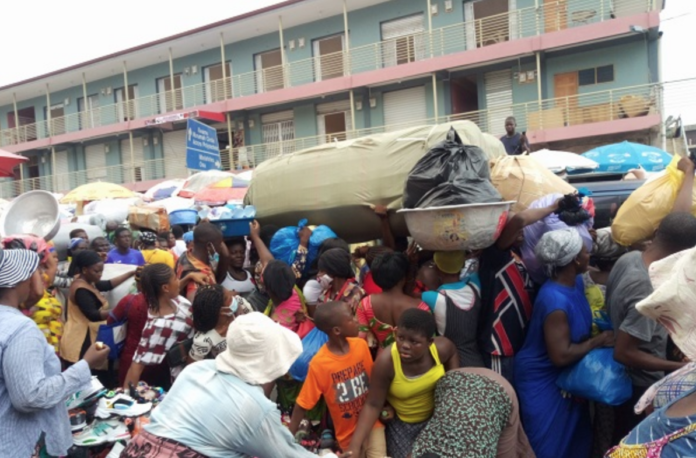 Shoppers on the street in front of the Makola Market in Accra.