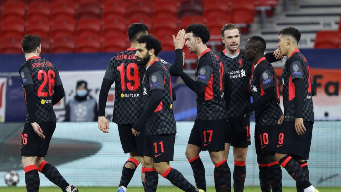 Sadio Mane of Liverpool celebrates with team mates Jordan Henderson and Roberto Firmino after scoring their side's second goal during the UEFA Champions League Round of 16 match between RB Leipzig and Liverpool FC at Puskas Arena on February 16, 2021 Image credit: Getty Images