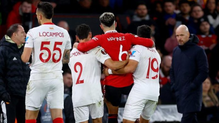 Lisandro Martinez was helped off the pitch by Sevilla's Gonzalo Montiel and Marcos Acuna who are his Argentina team-mates