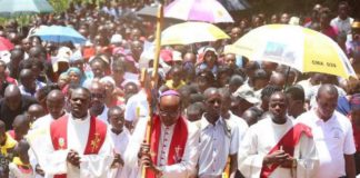 Nyeri Catholic Archbishop Antony Muheria carries a cross as led other faithful in a religious procession to Our Lady of Constanta Cathedral in Nyeri during a past event