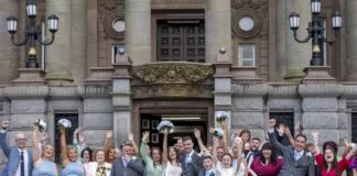 The couple and their friends and family on the big day ( Image: Clarity Wedding Photography / SWNS)