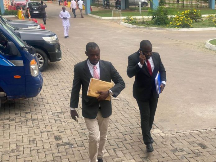 One of the witnesses, Sup. Eric Gyebi arrives with his lawyer.