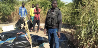 A man stands next to body bags of farmers that were victims of an attack, in the Zabarmari district, near Maiduguri, on November 6, 2023. Audu Marte | Afp | Getty Images