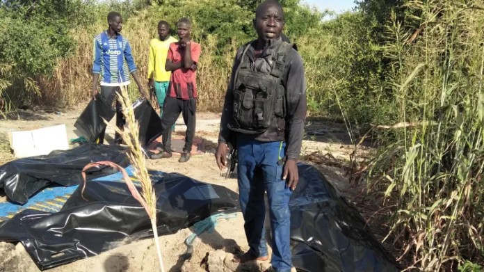 A man stands next to body bags of farmers that were victims of an attack, in the Zabarmari district, near Maiduguri, on November 6, 2023. Audu Marte | Afp | Getty Images