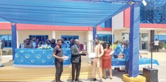 Prof. Alex Dodoo (2nd from left), Director-General, GSA, presenting a certificate to Atteh Adamtey, a certified electrical wiring professional, at the graduation ceremony