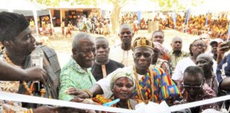 Kofi Dzamesi (2nd from left), CEO of Bui Power Authority, being assisted by some traditional rulers to perform the tape-cutting ceremony. Inset: The new classroom block