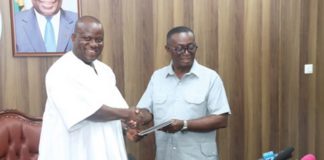 Andy Appiah Kubi (right), Chairman of the Devesting Committee and Member of Parliament for Asante-Akim North Constituency, presenting the report to Samuel Abu Jinapor (left), Minister of Lands and Natural Resources, after the meeting with the committee. Picture: ELVS NII NOI DOWUONA