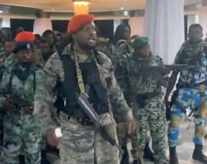 A man in military fatigues speaks as others stand next to him inside the Palace of the Nation during an attempted coup in Kinshasa, Democratic Republic of Congo, May 19, 2024, in this screen grab from a social media video. Christian Malanga/Reuters