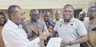 Benjamin Arthur (left), Chief Executive of FWSC, handing over the conditions of service to Prof. Mamudu Akudugu, UTAG National President