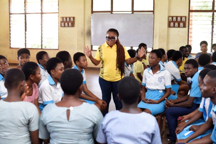 MTN staff volunteer engaging with students of Christ the King SHS in the Ashanti region