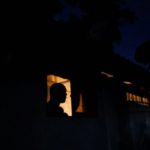 A man looks out from a window while talking to a person during the power cut in Colombo, Sri Lanka March 30, 2022. REUTERS/Dinuka Liyanawatte