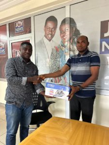 Adom FM Producer Tetteh Banafo presents a NASCO steam iron to Mr Dzisenu, winner of one of the prizes in the weekly draw