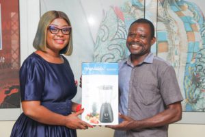 Adom FM Presenter Afia Amankwaa presents NASCO blender to George Opoku winner of one of the consolation prizes in monthly draw