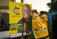 African National Congress (ANC) polling agents set up a tent decorated with party paraphernalia outside a polling station in Umlazi on May 29, during South Africa's general election. Zinyange Auntony/AFP via Getty Images