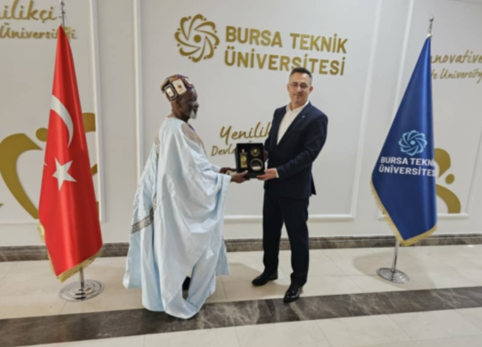 Ya-Na Abukari II receiving a souvenir from Prof Dr. Naci Caglar, VC of Bursa Technical University in Bursa, Turkey after a co-operation meeting.