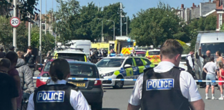 Emergency services and police are seen at the scene of a stabbing in Southport, England on Monday. ChauffeurWest/X via PA Wire