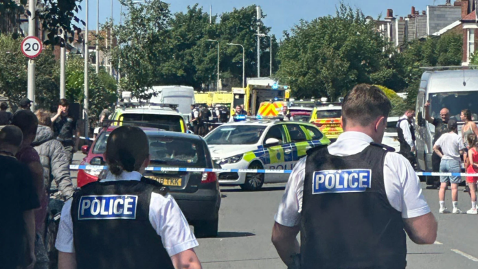 Emergency services and police are seen at the scene of a stabbing in Southport, England on Monday. ChauffeurWest/X via PA Wire