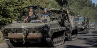 Ukrainian servicemen ride an armoured personnel carrier, near the Russian border in Sumy region, Ukraine, on Wednesday. Viacheslav Ratynskyi/Reuters