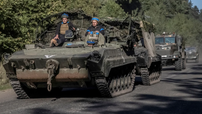 Ukrainian servicemen ride an armoured personnel carrier, near the Russian border in Sumy region, Ukraine, on Wednesday. Viacheslav Ratynskyi/Reuters