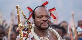 King Mswati III, who took the throne in 1986, arrives in ceremonial dress for the annual reed dance