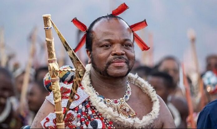 King Mswati III, who took the throne in 1986, arrives in ceremonial dress for the annual reed dance