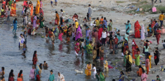 Hindustan Times via Getty Images The annual Jivitputrika festival is celebrated in several states in north-eastern India. In this 2020 photo, women and children are seen bathing in a river in the Uttar Pradesh state.