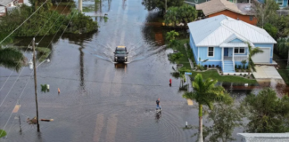 Joe Raedle / Getty Images Residents had to wade through floodwaters after heavy rain in Punta Gorda