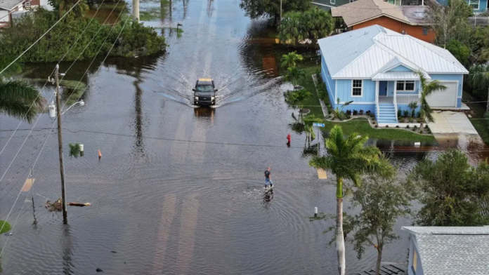 Joe Raedle / Getty Images Residents had to wade through floodwaters after heavy rain in Punta Gorda