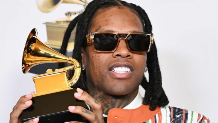 Getty Images | Lil Durk holding the Grammy Award he won for best melodic rap performance in February