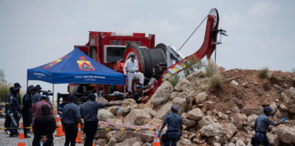 Members of the South African police, patrol as they guard the mine shaft where rescue operations are ongoing as attempts are made to rescue illegal miners who have been underground for months in Stilfontein, South Africa, January 14, 2025. REUTERS/Ihsaan Haffejee