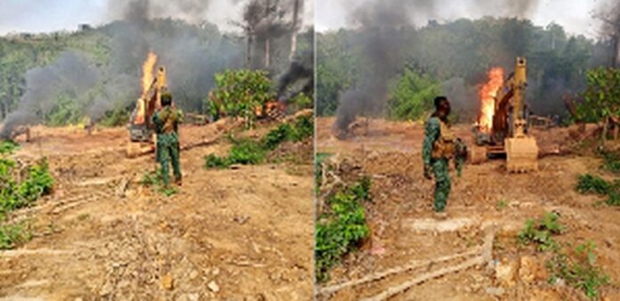 The excavators being burnt after the raid on illegal miners